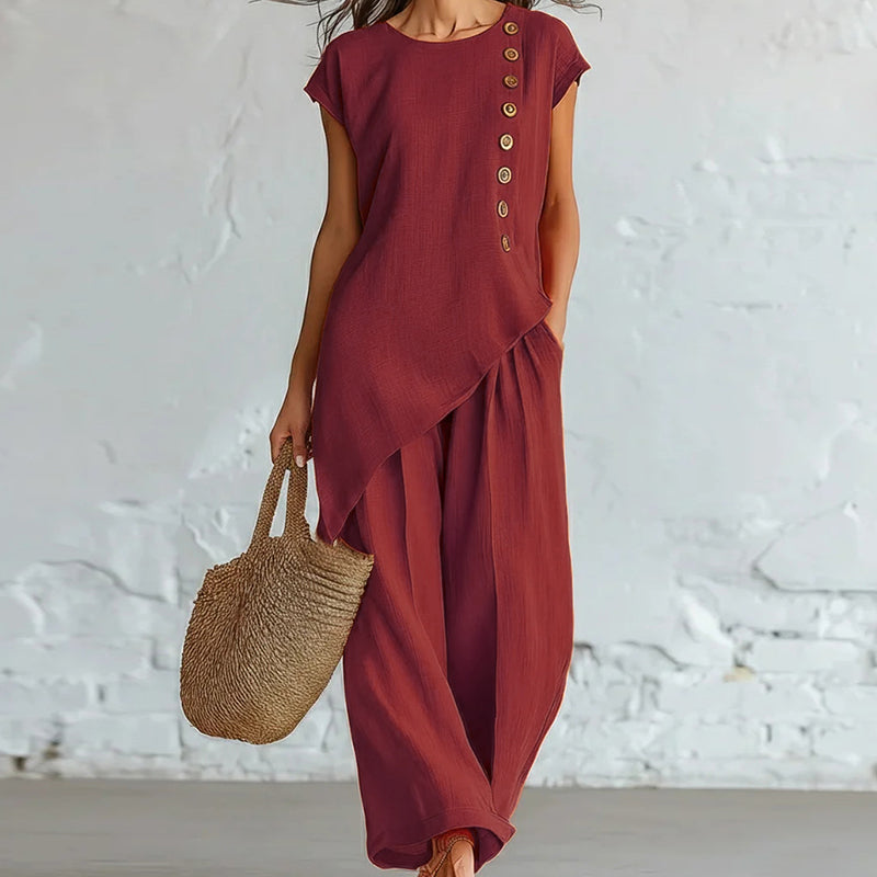 Damesset bestaande uit een top en een broek met asymmetrische zoom, 2-delig