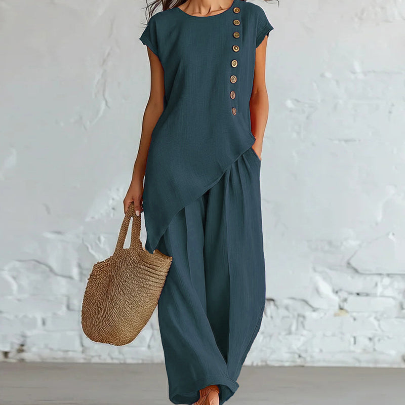 Damesset bestaande uit een top en een broek met asymmetrische zoom, 2-delig