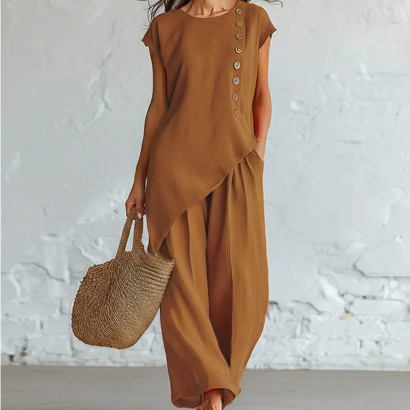 Damesset bestaande uit een top en een broek met asymmetrische zoom, 2-delig