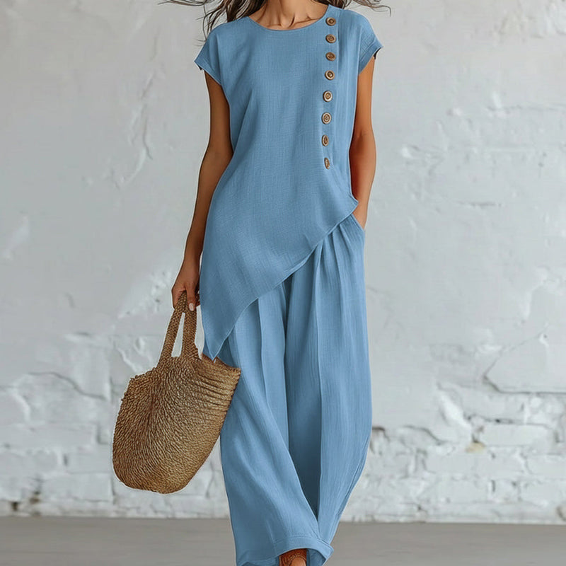 Damesset bestaande uit een top en een broek met asymmetrische zoom, 2-delig