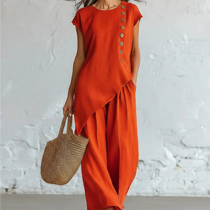 Damesset bestaande uit een top en een broek met asymmetrische zoom, 2-delig