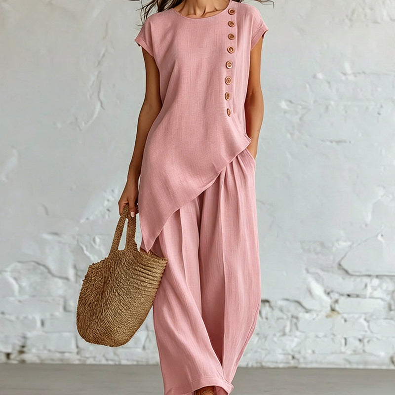 Damesset bestaande uit een top en een broek met asymmetrische zoom, 2-delig